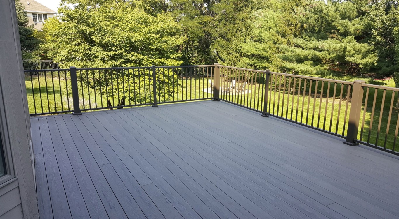 Modern gray composite deck with black metal railings installed by TLD Turlock Deck Builder