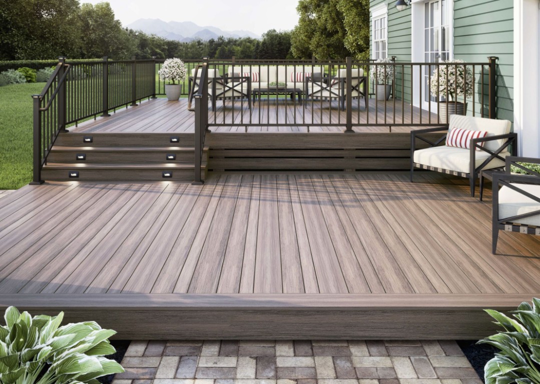 Multi-level composite deck with stairs and black railings designed for outdoor living